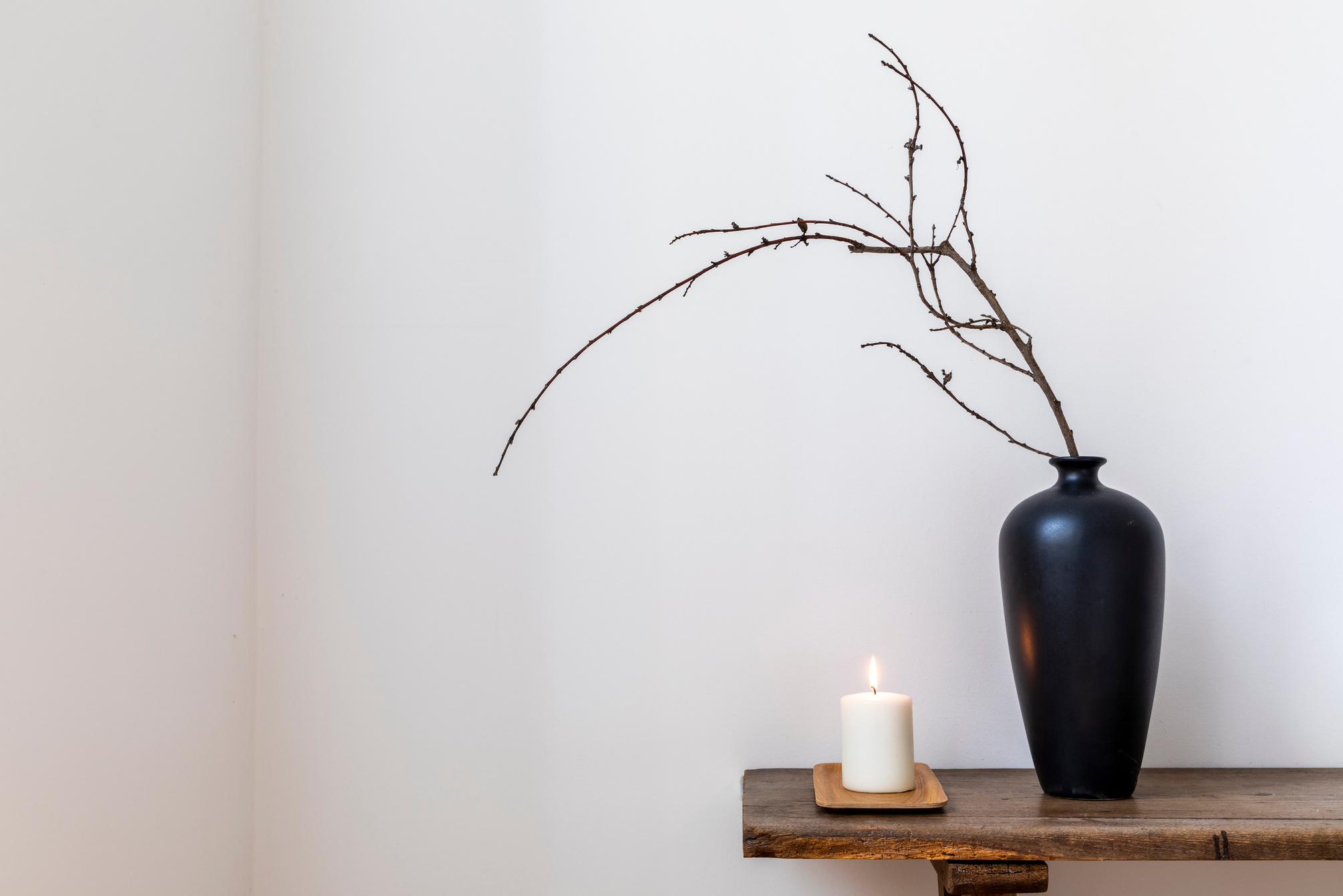 Lighted Candle with Black Vase